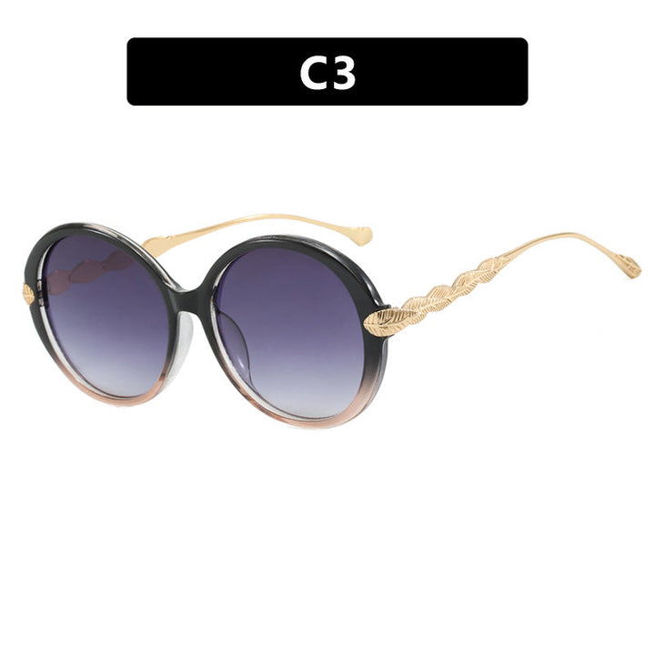 Dame stor rund solbrille med dekorative metalakser Luvikno