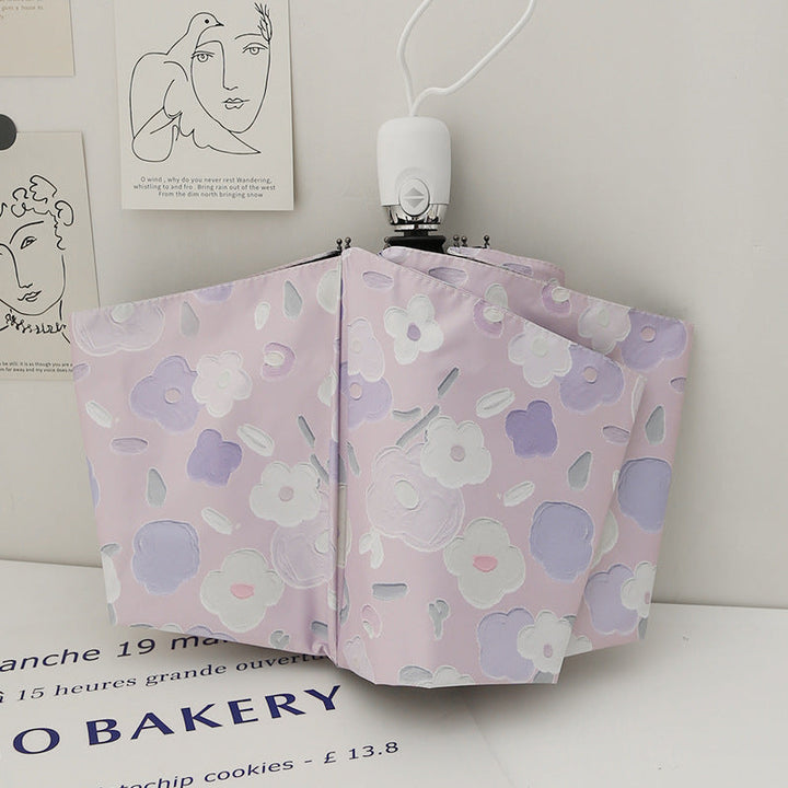 Dame sammenleggbar paraply med stilfullt blomstedesign Luvikno